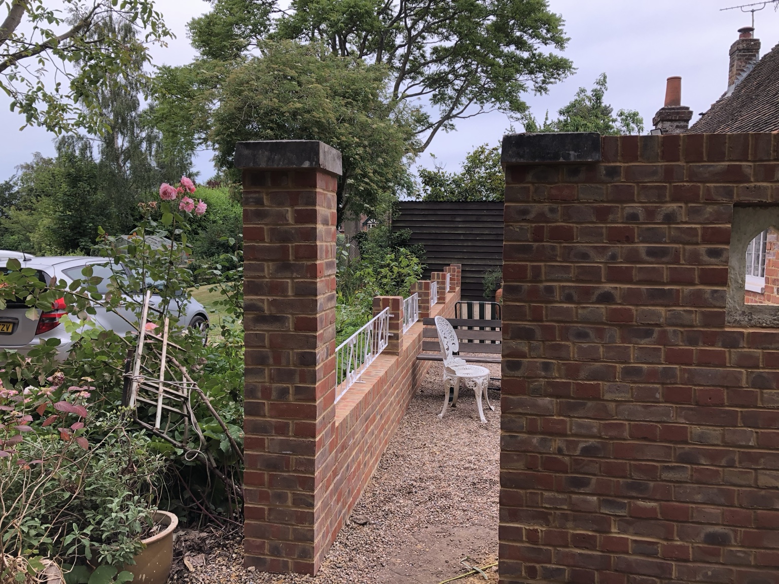 Brick gate piers beside a garden wall